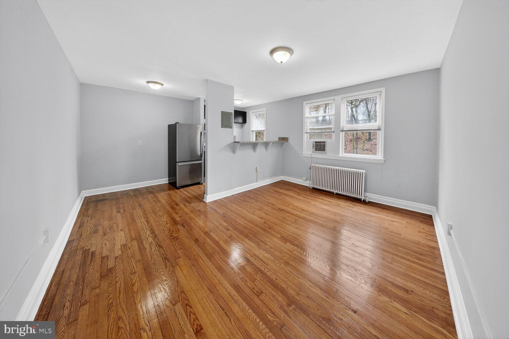 4703 Ravenswood Road, Unit 25 Riverdale, MD 20737 - Photo 3 of 12 a view of a livingroom with wooden floor and a window