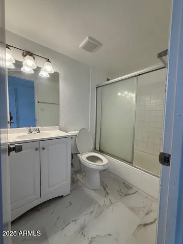 a bathroom with a toilet sink and shower