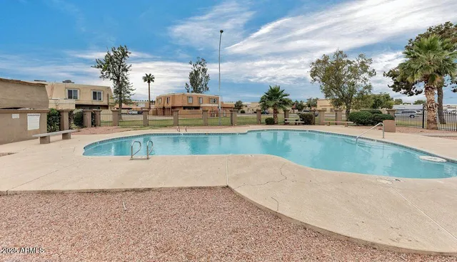 a view of a swimming pool with outdoor seating