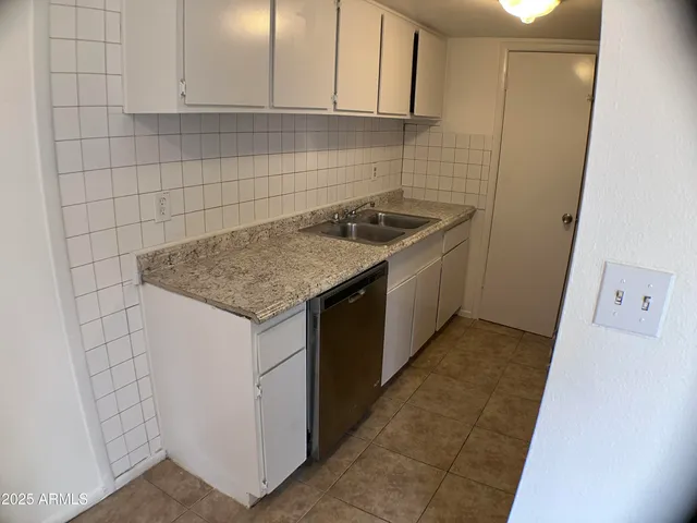 a kitchen with a sink stove and cabinets