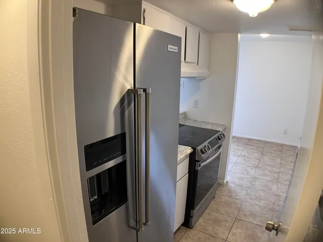 a kitchen with a refrigerator and a stove