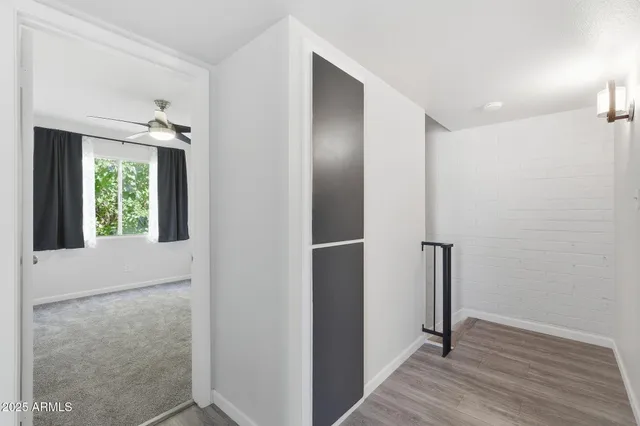 a view of hallway with closet and a window