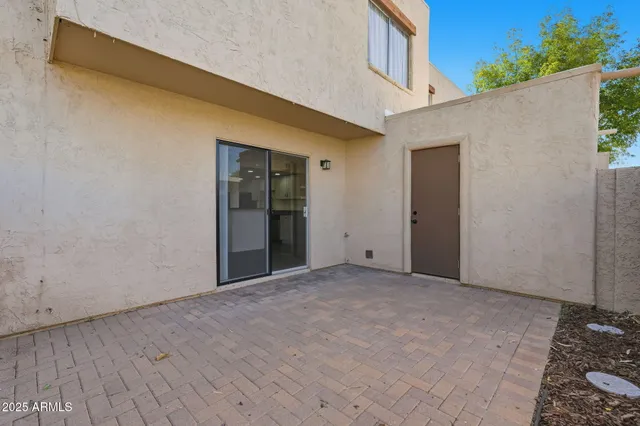 a view of an empty room with wooden floor and a potted plant