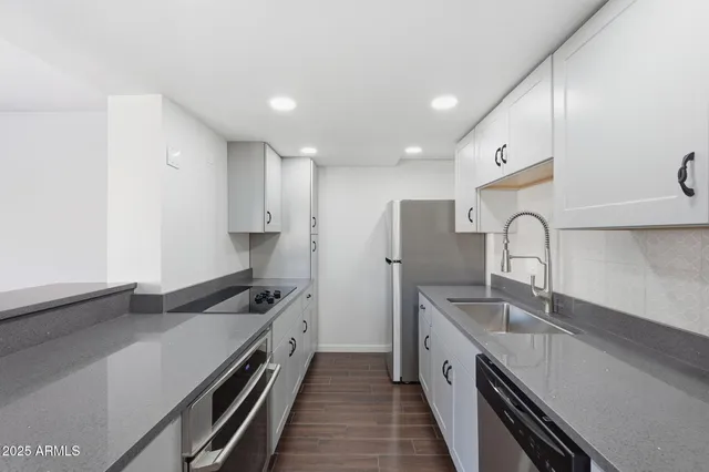 a kitchen with a sink and a refrigerator