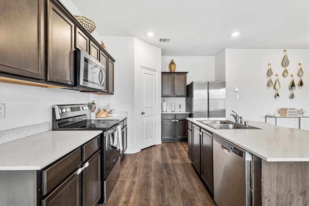 1231 Delmita Drive Forney, TX 75126 - Photo 15 of 38 a kitchen with stainless steel appliances granite countertop a stove a sink dishwasher and a refrigerator
