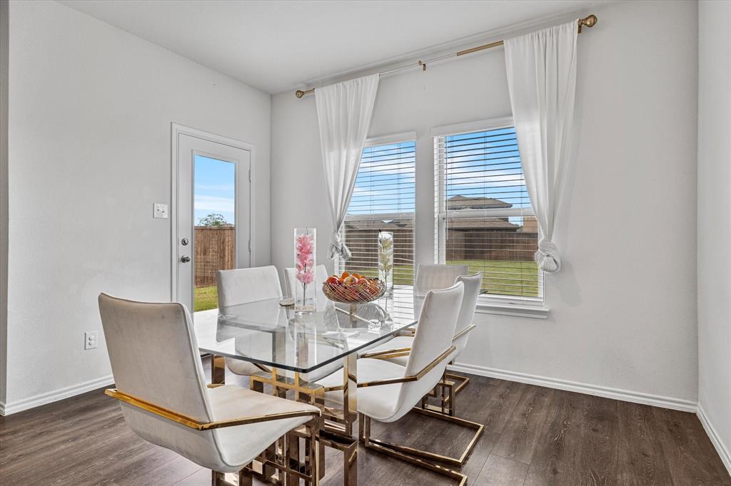 1231 Delmita Drive Forney, TX 75126 - Photo 16 of 38 a view of a dining room with furniture and wooden floor