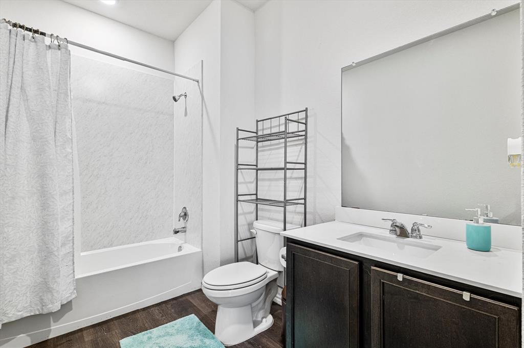 1231 Delmita Drive Forney, TX 75126 - Photo 18 of 38 a bathroom with a sink a toilet and shower