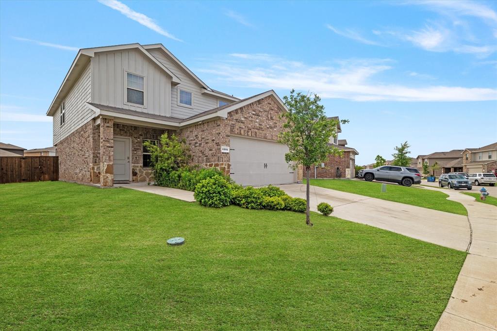 1231 Delmita Drive Forney, TX 75126 - Photo 2 of 38 a front view of a house with garden