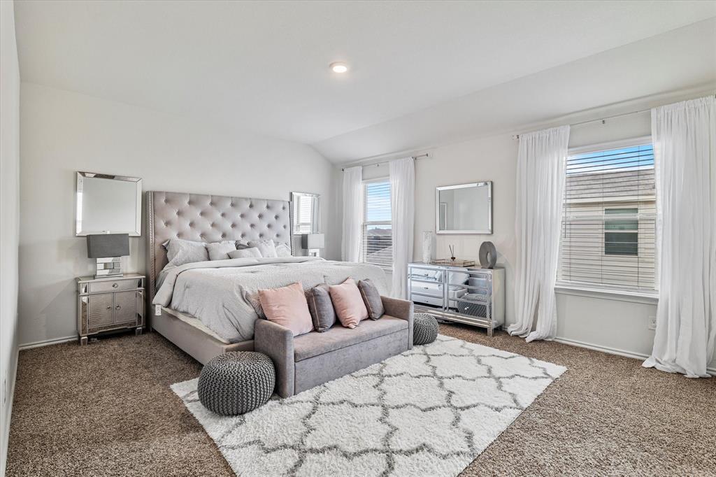 1231 Delmita Drive Forney, TX 75126 - Photo 23 of 38 a spacious bedroom with a bed and walk in closet