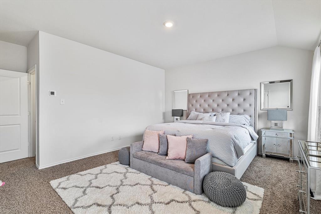 1231 Delmita Drive Forney, TX 75126 - Photo 24 of 38 a bedroom with a bed and a couch