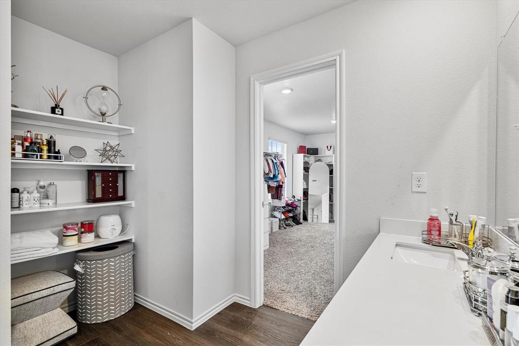 1231 Delmita Drive Forney, TX 75126 - Photo 25 of 38 a en suite bathroom with a sink and a mirror