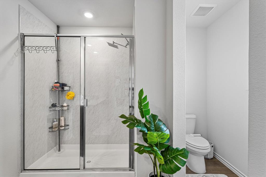 1231 Delmita Drive Forney, TX 75126 - Photo 26 of 38 a bathroom with a sink a toilet and shower