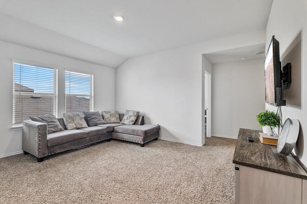 1231 Delmita Drive Forney, TX 75126 - Photo 29 of 38 a living room with furniture and a flat screen tv