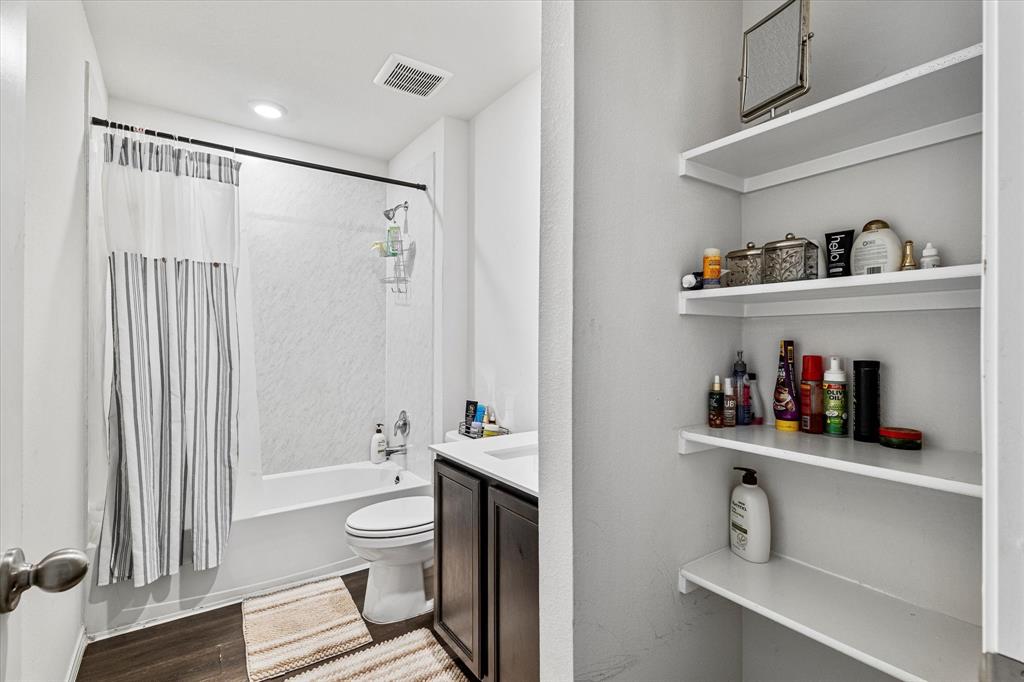 1231 Delmita Drive Forney, TX 75126 - Photo 31 of 38 a bathroom with a toilet a sink and a shower