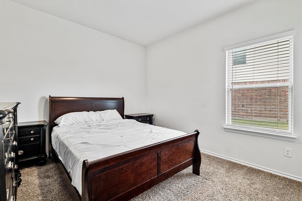 1231 Delmita Drive Forney, TX 75126 - Photo 34 of 38 a bed sitting in a bedroom next to a window
