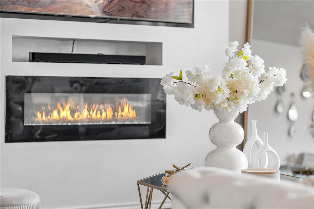 1231 Delmita Drive Forney, TX 75126 - Photo 10 of 38 a room with a fireplace and chandelier