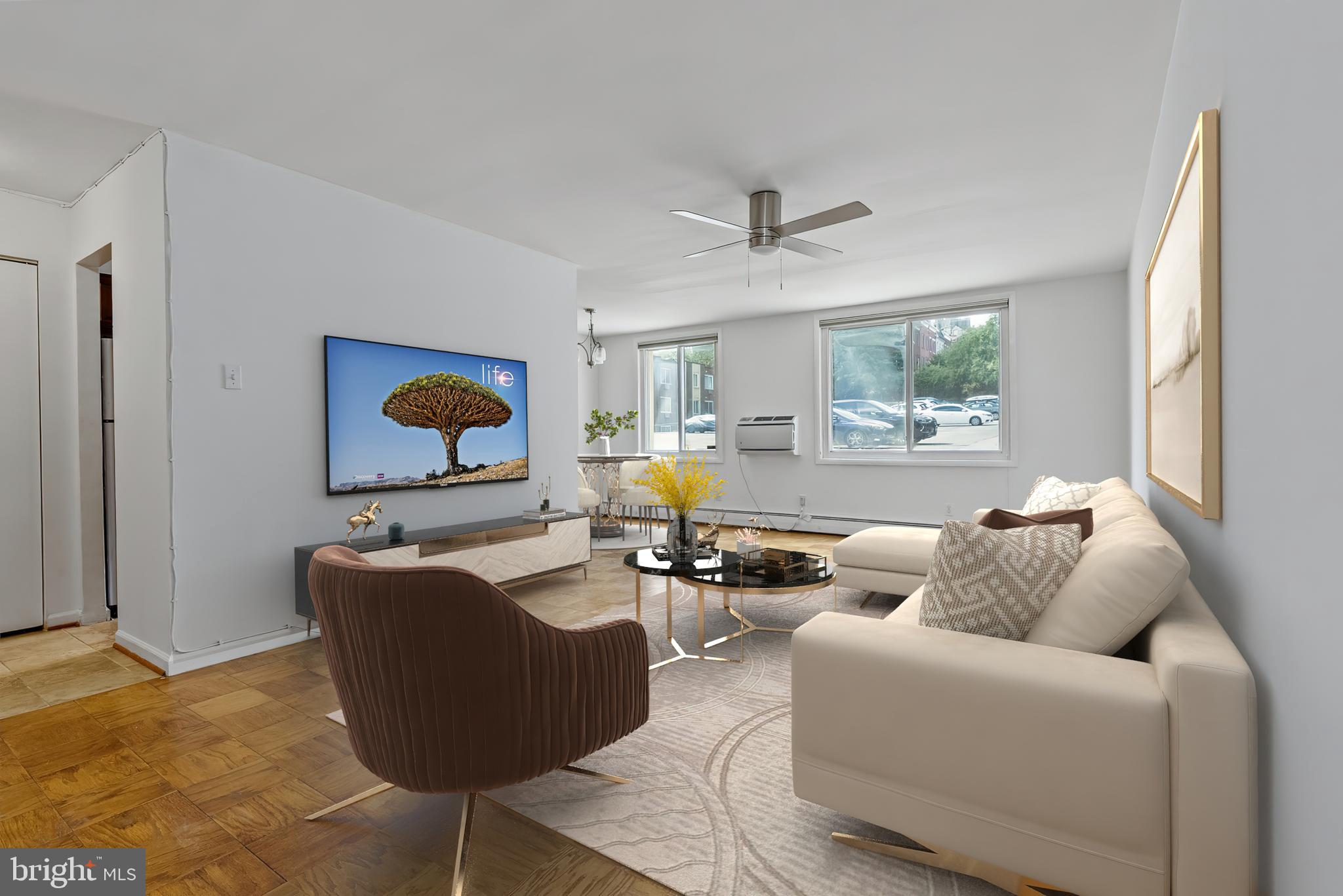 a living room with furniture wooden floor and a window