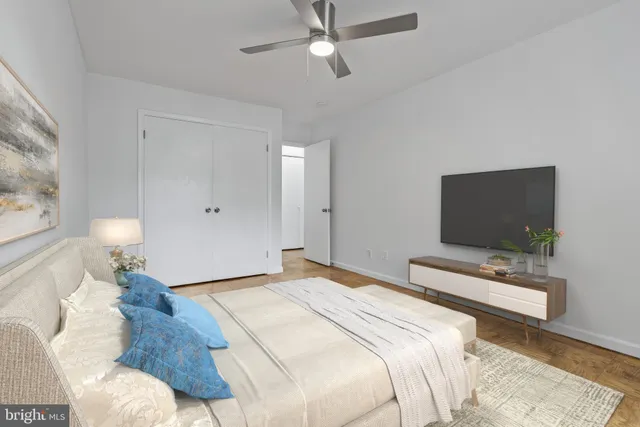 a bedroom with a bed and a flat screen tv