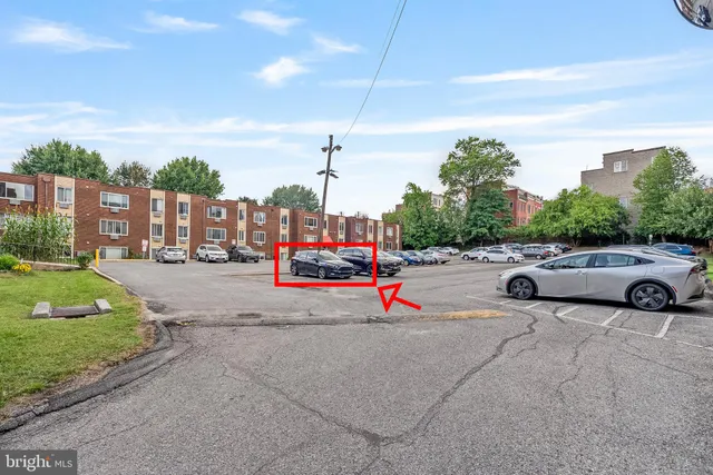 a view of a city street with a parked car