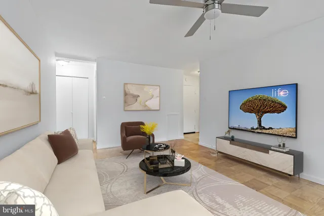a living room with furniture and a wall painting