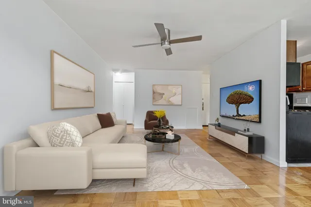 a living room with furniture and wooden floor