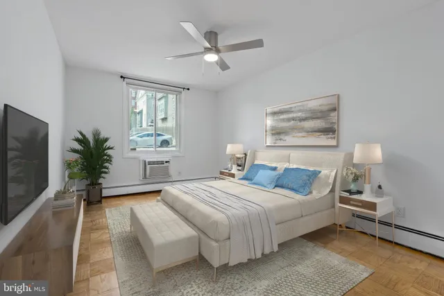 a bedroom with a large bed and a potted plant