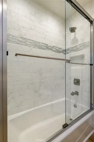 a bathroom with a bathtub and a shower