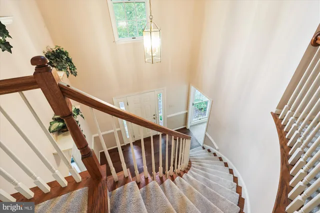 a view of a hallway view with wooden floor and staircase