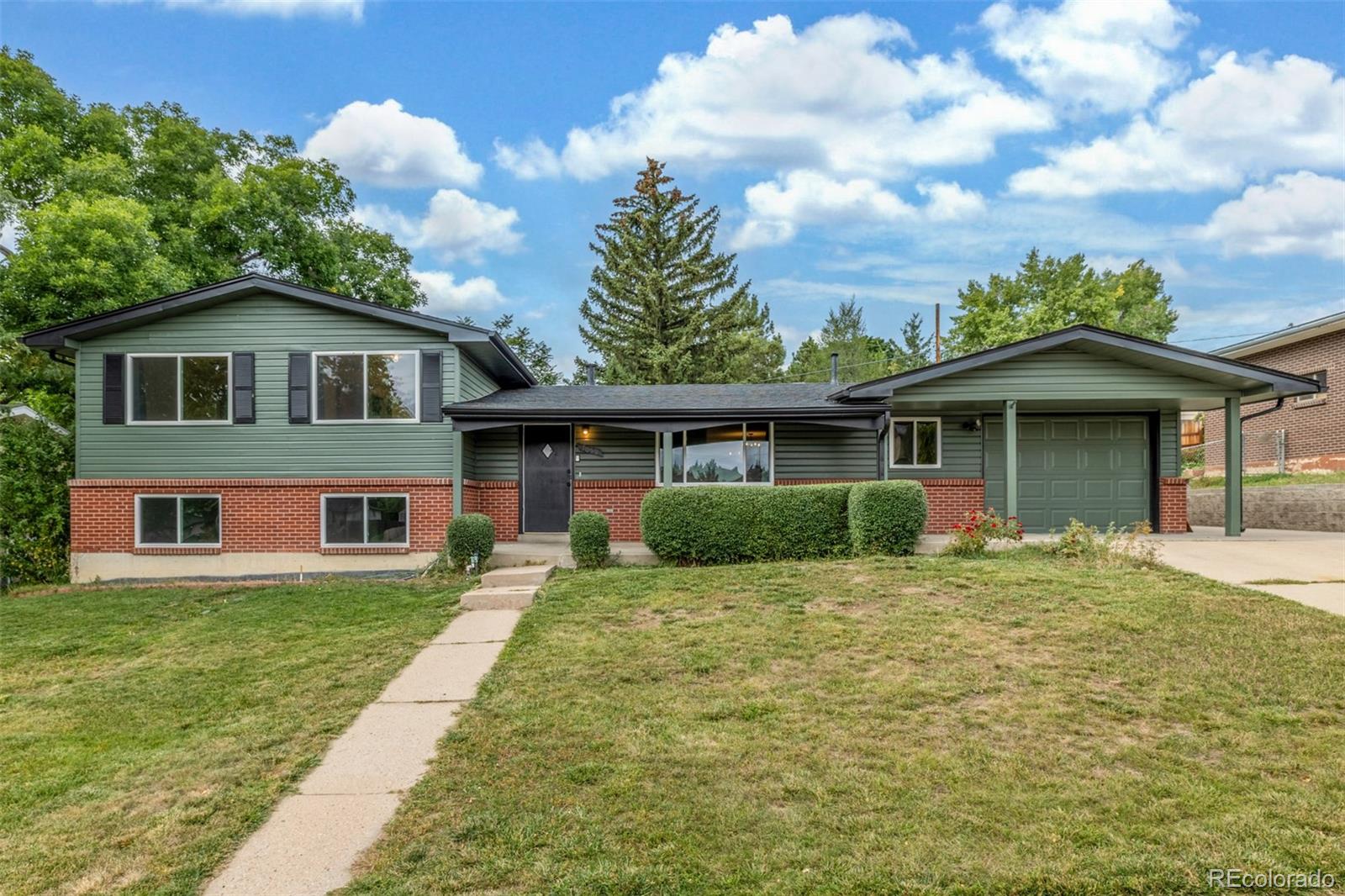 a front view of a house with a yard