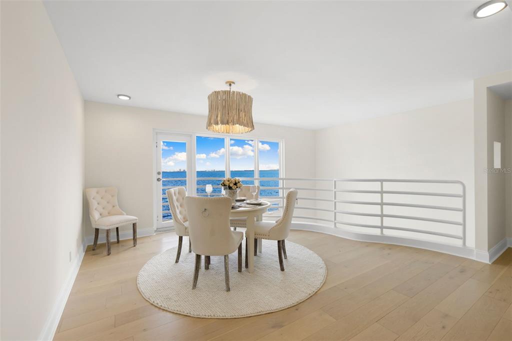 4950 Bayshore Boulevard, Unit 23 Tampa, FL 33611 - Photo 12 of 40 a view of a dining room with furniture a chandelier and wooden floor