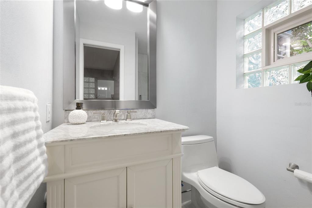 4950 Bayshore Boulevard, Unit 23 Tampa, FL 33611 - Photo 16 of 40 a bathroom with a sink vanity mirror and toilet