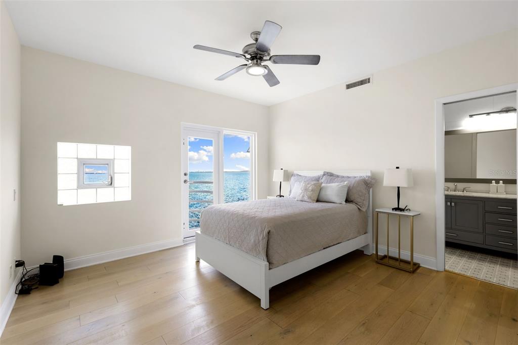 4950 Bayshore Boulevard, Unit 23 Tampa, FL 33611 - Photo 26 of 40 a spacious bedroom with a bed and a ceiling fan
