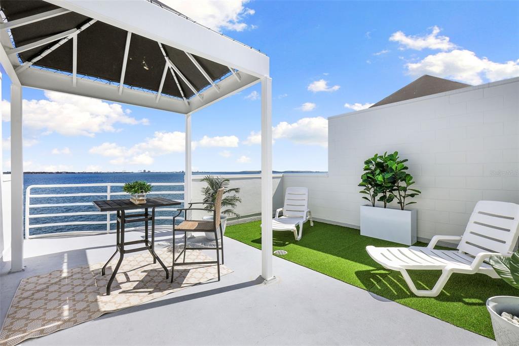 4950 Bayshore Boulevard, Unit 23 Tampa, FL 33611 - Photo 29 of 40 a view of a porch with furniture and a yard