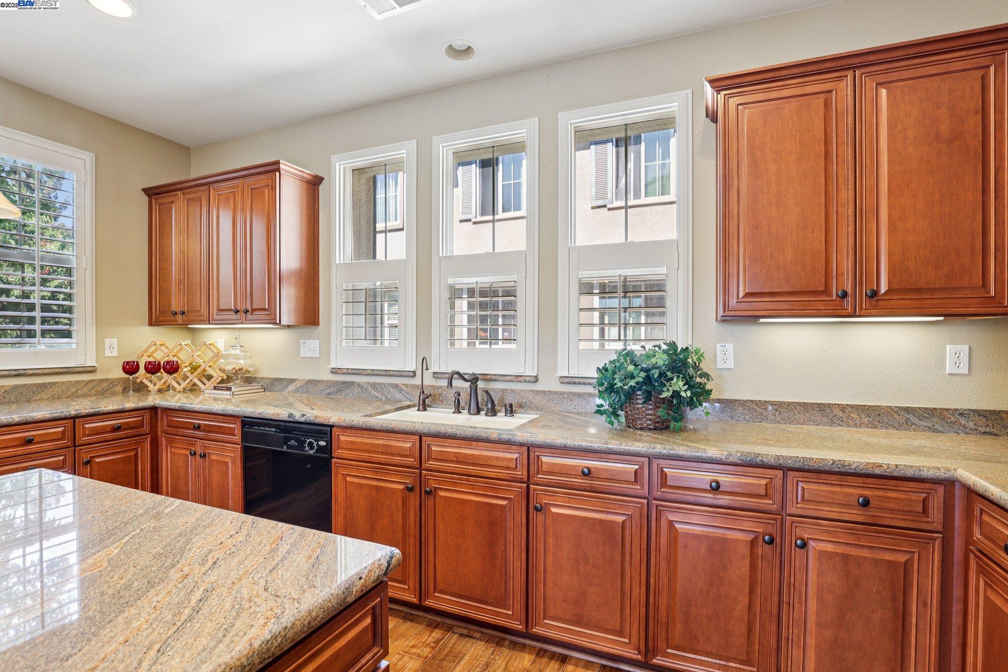622 Moss Way Hayward, CA 94541 - Photo 13 of 25 a kitchen with stainless steel appliances granite countertop wooden cabinets a sink and dishwasher with wooden floor
