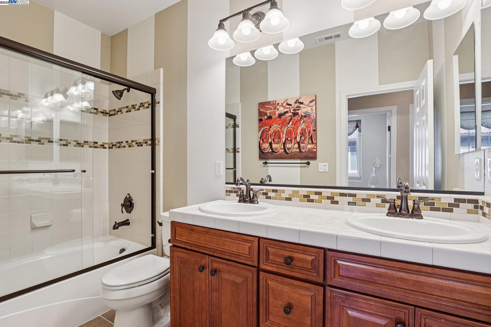 622 Moss Way Hayward, CA 94541 - Photo 17 of 25 a bathroom with a sink a toilet and a large mirror