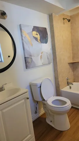 a white toilet sitting next to a bathroom sink
