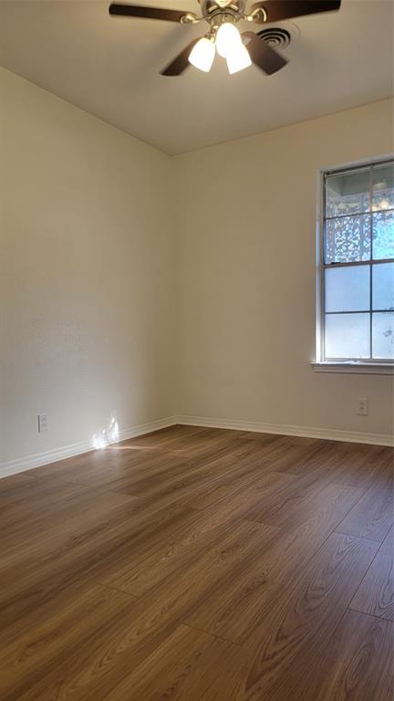 2001 East Alma Avenue Sherman, TX 75090 - Photo 5 of 16 an empty room with wooden floor and windows