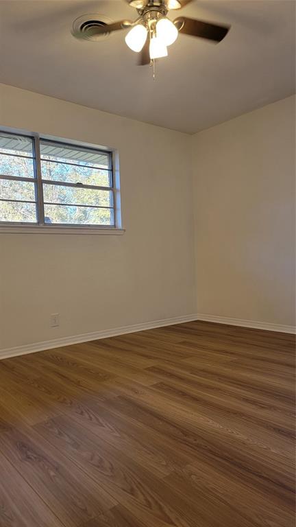 2001 East Alma Avenue Sherman, TX 75090 - Photo 7 of 16 a view of an empty room with wooden floor and a window