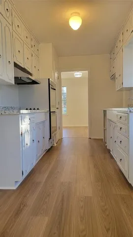 a view of a kitchen with wooden floor