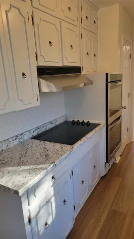 a kitchen with granite countertop cabinets and steel stainless steel appliances
