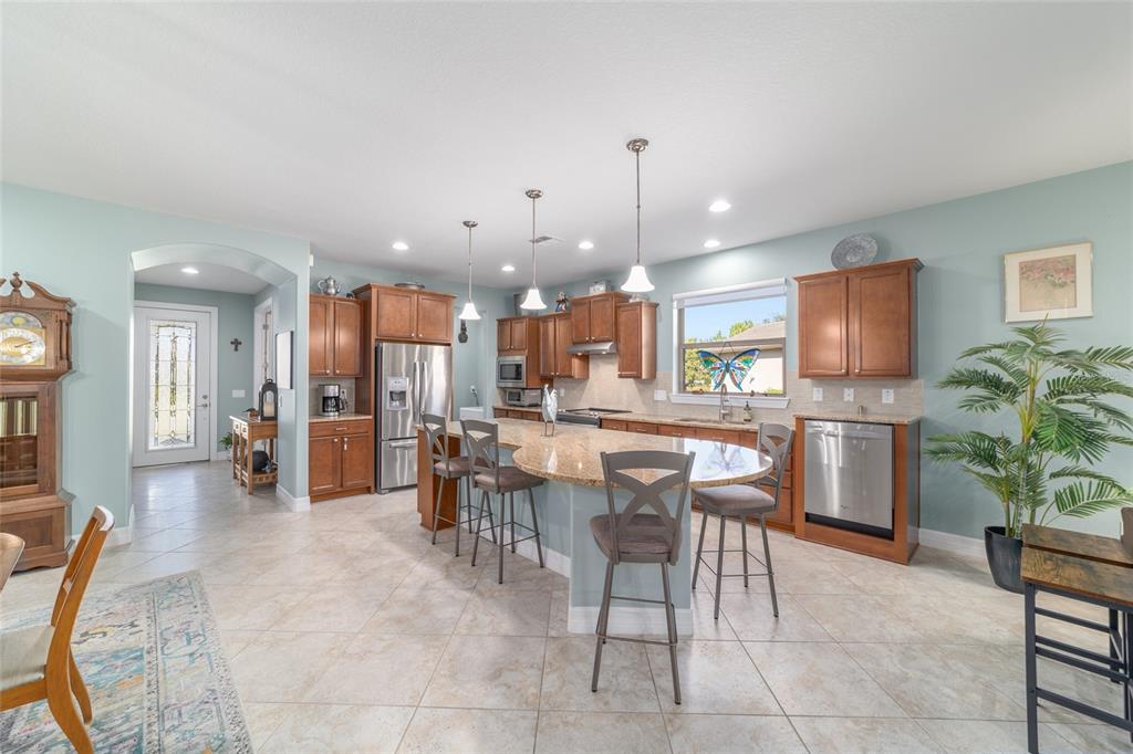 10106 Southwest 77th Loop Ocala, FL 34481 - Photo 15 of 69 a large kitchen with a table and chairs