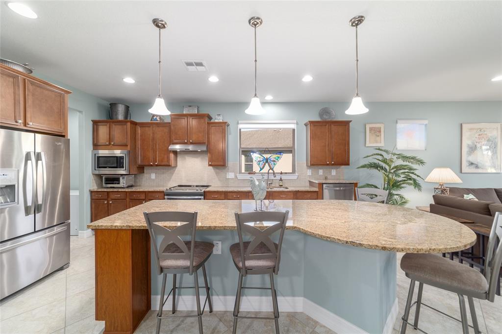 10106 Southwest 77th Loop Ocala, FL 34481 - Photo 16 of 69 a large kitchen with a table and chairs