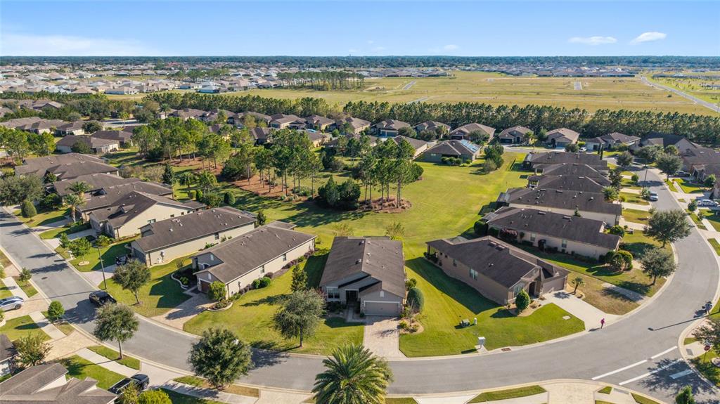 10106 Southwest 77th Loop Ocala, FL 34481 - Photo 2 of 69 an aerial view of residential houses with outdoor space and ocean view