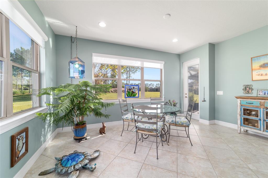 10106 Southwest 77th Loop Ocala, FL 34481 - Photo 25 of 69 a living room with furniture a piano and a potted plant