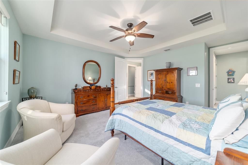 10106 Southwest 77th Loop Ocala, FL 34481 - Photo 32 of 69 a bedroom with a bed and a chandelier