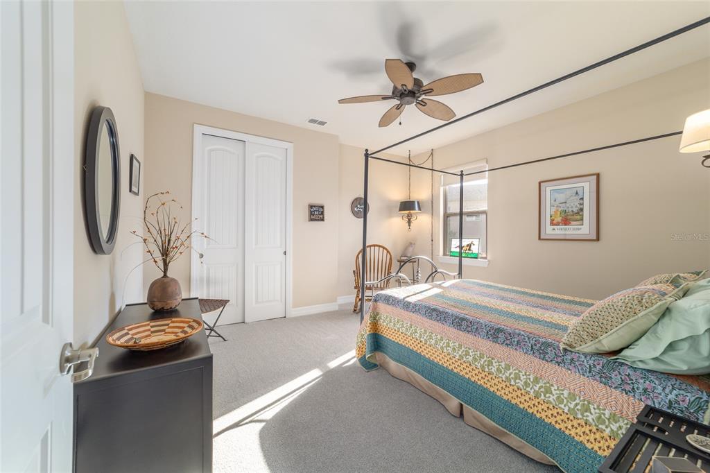 10106 Southwest 77th Loop Ocala, FL 34481 - Photo 36 of 69 a bed room with a bed and a chandelier