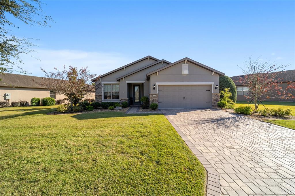 10106 Southwest 77th Loop Ocala, FL 34481 - Photo 4 of 69 a front view of a house with a yard