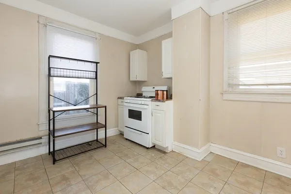 a stove top oven sitting inside of a kitchen