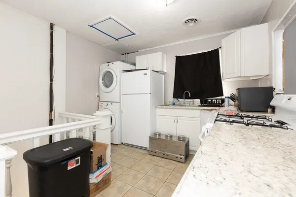 a kitchen with a stove and a refrigerator