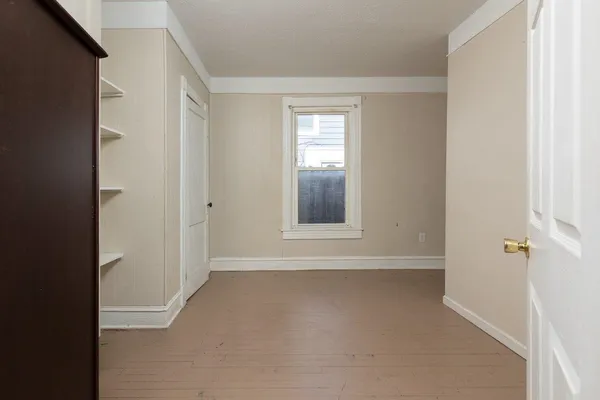 an empty room with a empty space and window